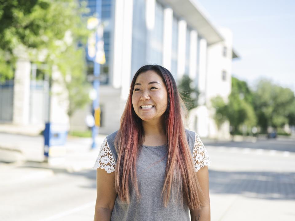 Smiling student outside RJF Hall