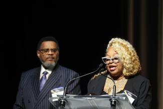 A person speaks from a podium.
