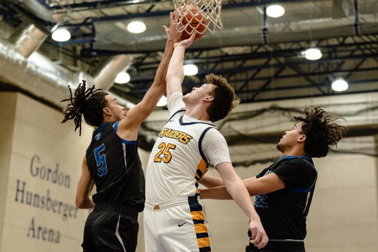 Alex Ehnis making a basket during a basketball game