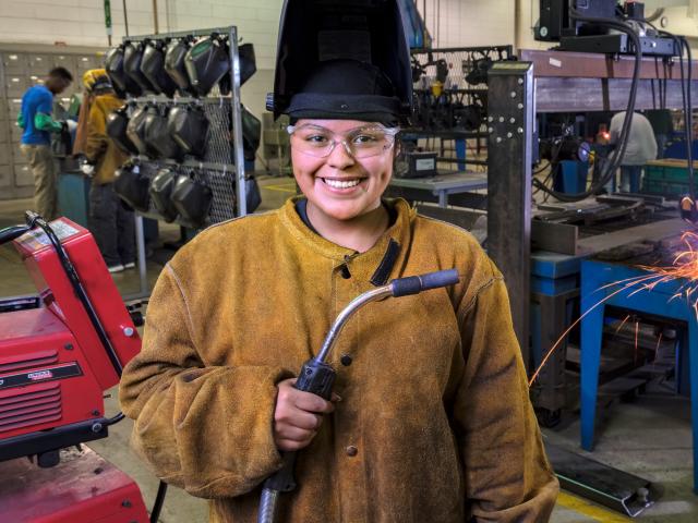 Metallica Scholars welding student in the machine shop.